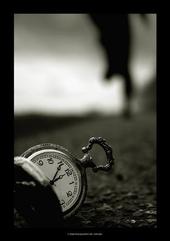 a pocket watch lying in sand